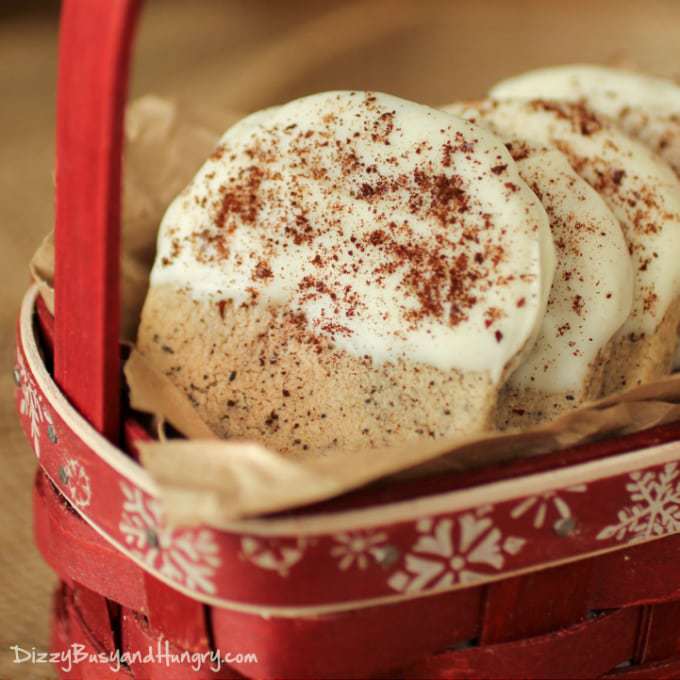 Close up shot of a red basket filled with white chocolate dipped coffee shortbread cookies. 