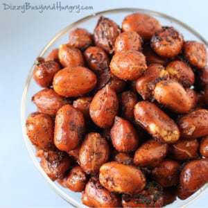 Overhead shot of chipotle lime roasted peanuts in a clear glass.