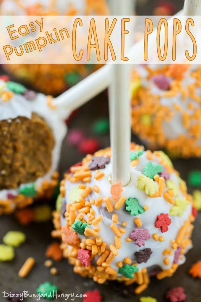 Close up shot of pumpkin cake pops on a black surface. 