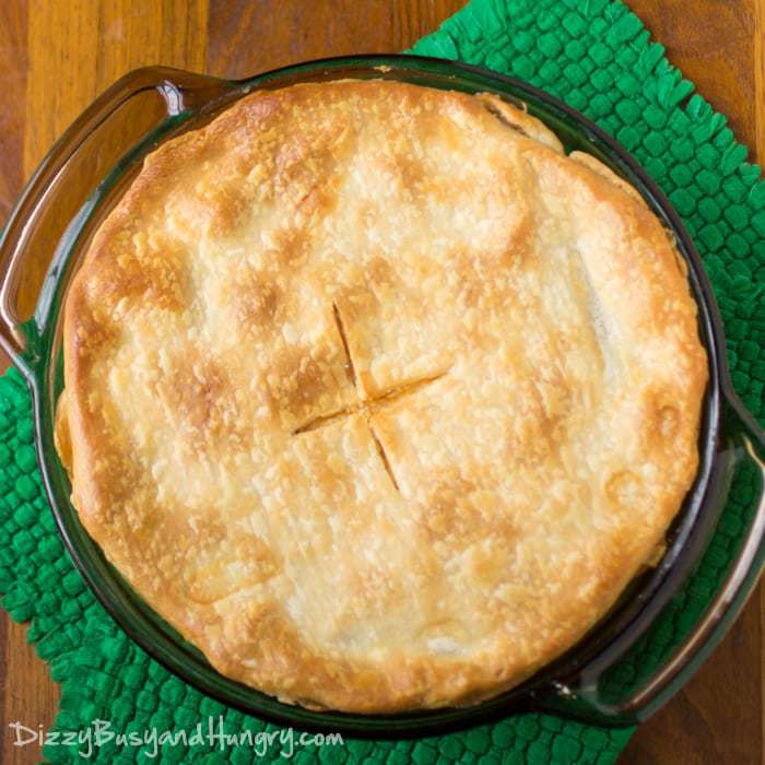 Overhead shot of whole seafood pot pie in the pan on a green cloth. 