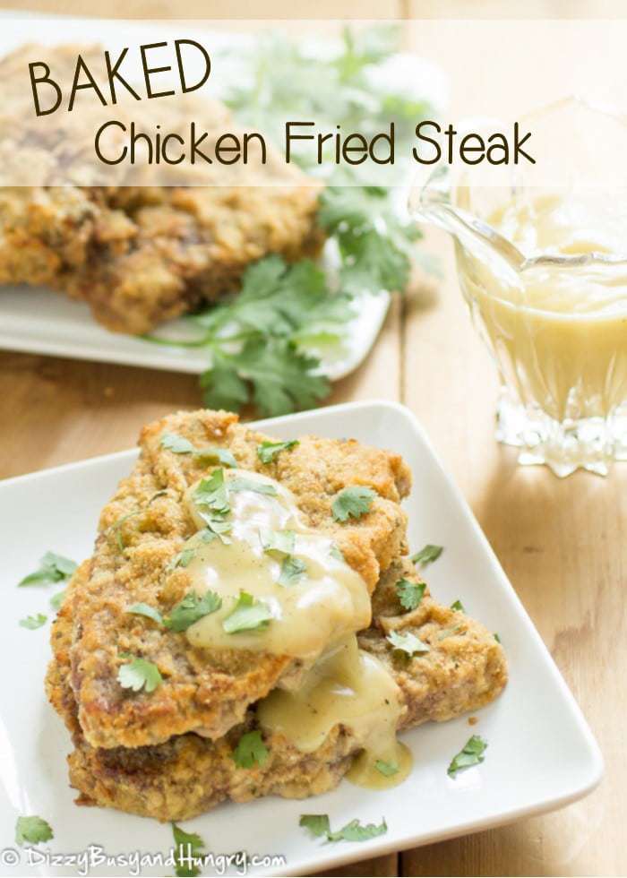 Chicken fried steak on a white plate with yellow gravy. 