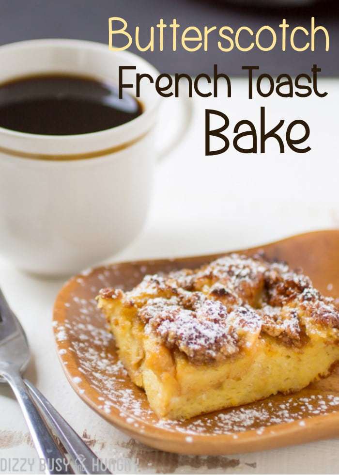 Butterscotch French toast bake on a wooden plate sprinkled with powdered sugar with a cup of coffee in the background. 