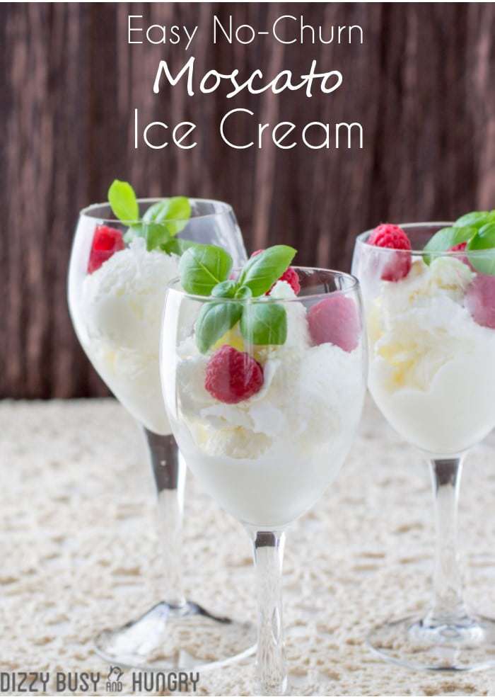 Side shot of moscato ice cream in three wine glasses garnished with mint and raspberries. 