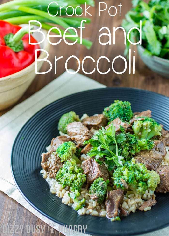 Facet behold of crock pot crimson meat and broccoli on a dim plate on a white cloth with peppers and herbs within the background.  Crock Pot Beef and Broccoli crock pot recipes beef and broccoli title