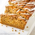 Banana bread sliced and drizzled with vanilla frosting