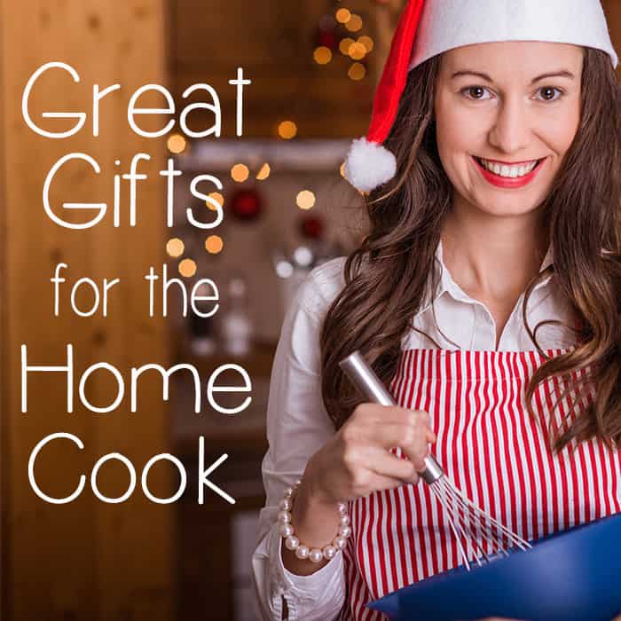 Side view of a woman with a Santa hat holding a mixing bowl. 