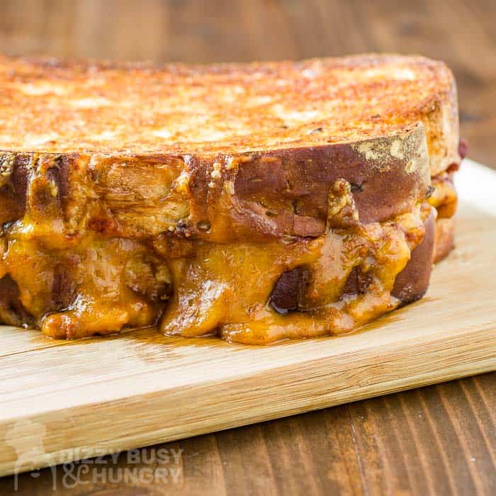 freshly grilled chili cheese sandwich on a cutting board