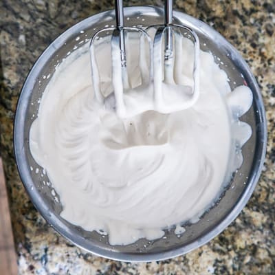 Overhead view of process shot- whipped cream in a bowl after being beaten. 