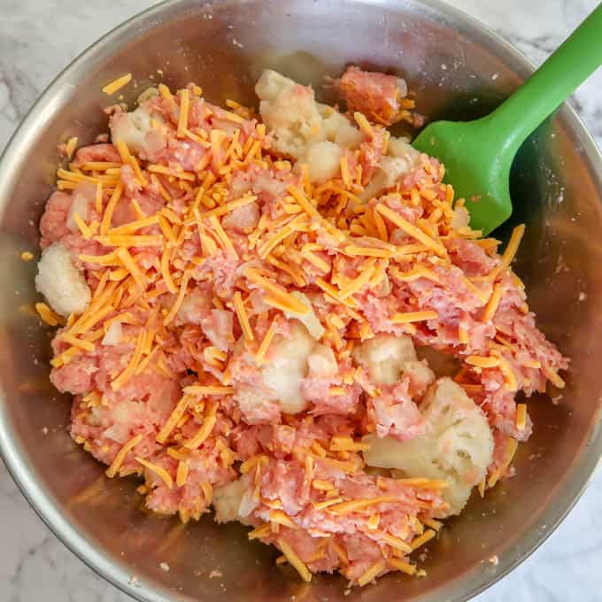 Overhead view of process shot- ground turkey, onion, ketchup, cauliflower, and shredded cheese mixed together. 
