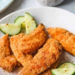 front view of chicken tenders on a grey plate - Cheap Chicken Recipes