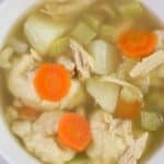 Top view of Chicken Dumping soup with carrots and celery