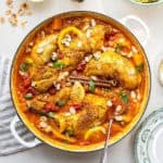 Top view of Morocon chicken with sauce in a white pan - Cheap Chicken Recipes