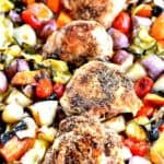Top view of chicken thighs surrounded by fresh vegetables in a casserole dish - cheap chicken recipes
