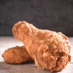 Front view of a fried chicken on top of another fried chicken
