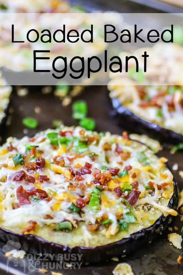 Close up shot of a finished eggplant round loaded with cheese, bacon bits, and scallions, on a baking sheet.