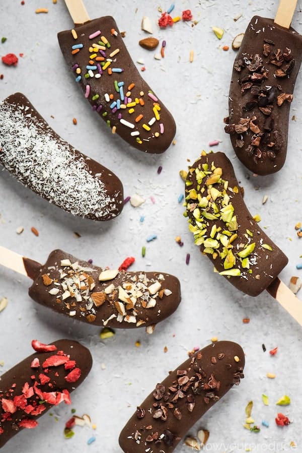 Top view of frozen chocolate bananas with popsicle sticks