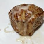 top view of a single cinnamon roll drizzled with sweet sauce by Cook Eat Go
