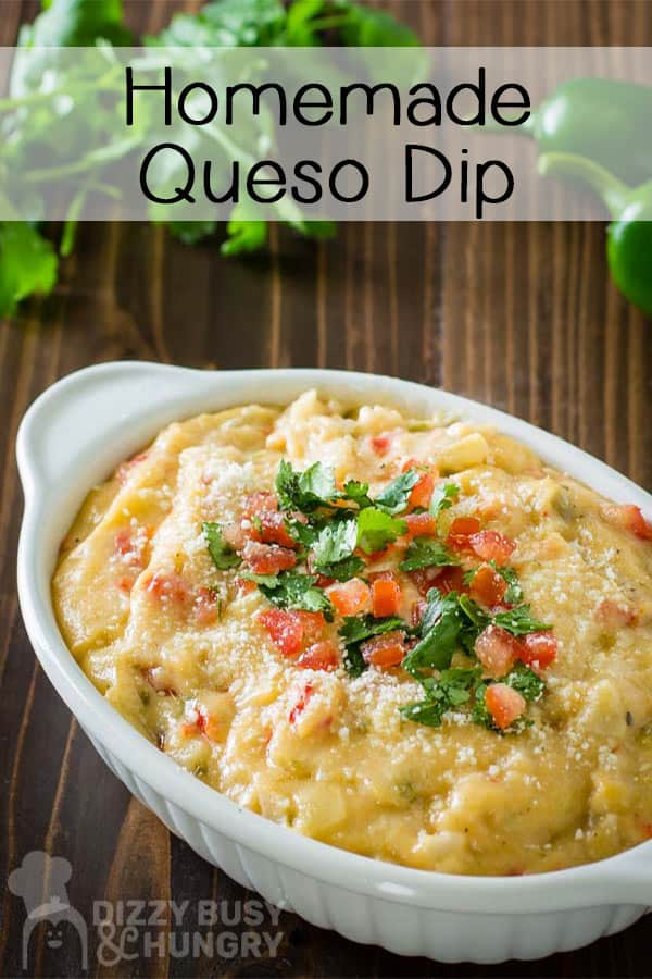 Side shot of homemade queso dip in an oval dish garnished with chopped cilantro and diced tomato.