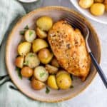 bowl of instant pot chicken breasts with a side of potatoes