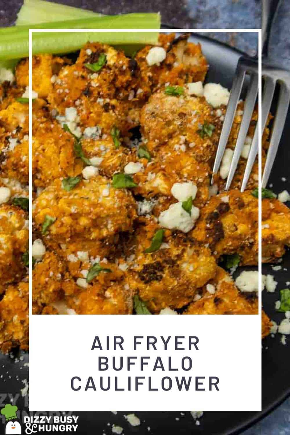 Close up shot of buffalo cauliflower on a black plate sprinkled with cheese crumbles and herbs with a fork and celery on the side.