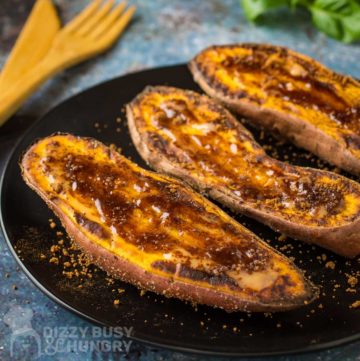 Side view of sweet potatoes topped with a brown sugar mixture that has melted on top of the potato.