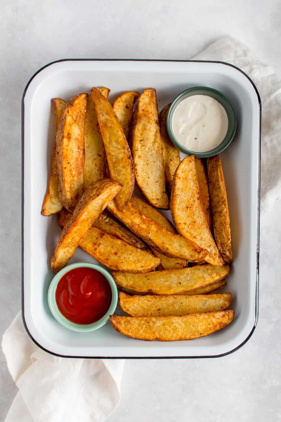 Overhead view of a tray of air fryer potato wedges.
