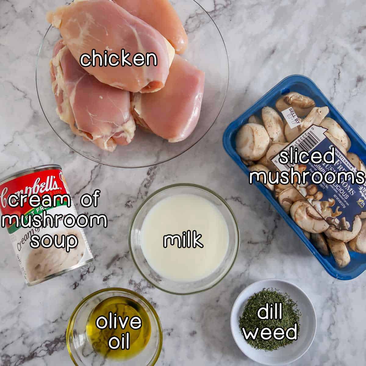 Overhead shot of main ingredients- chicken, sliced mushrooms, cream of mushroom soup, milk, olive oil, and dill weed.