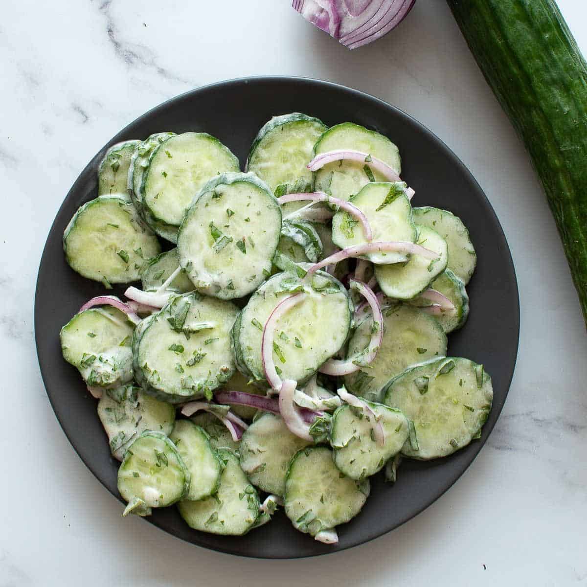 Cucumber salad with onion on a plate.