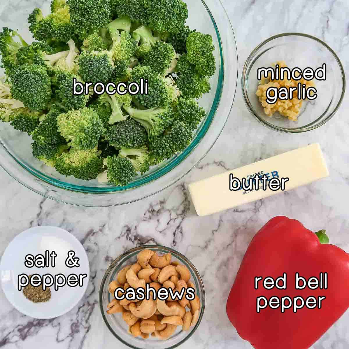 Overhead shot of ingredients- broccoli, minced garlic, butter, red bell pepper, cashews, salt, and pepper.