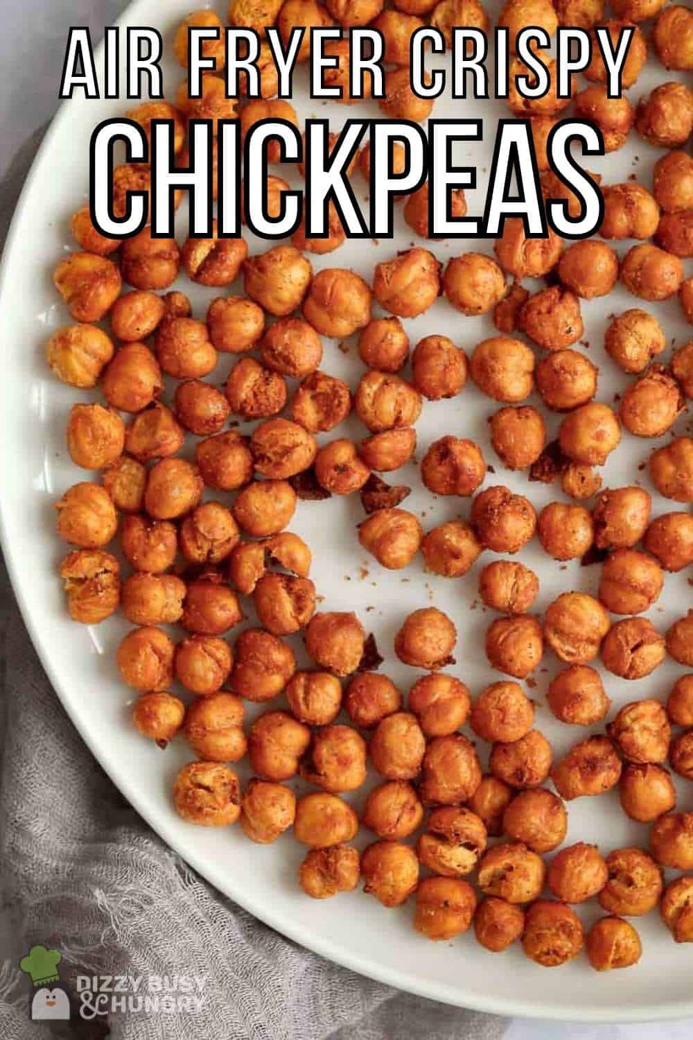 Overhead shot of crispy chickpeas on a white plate on a grey cloth.