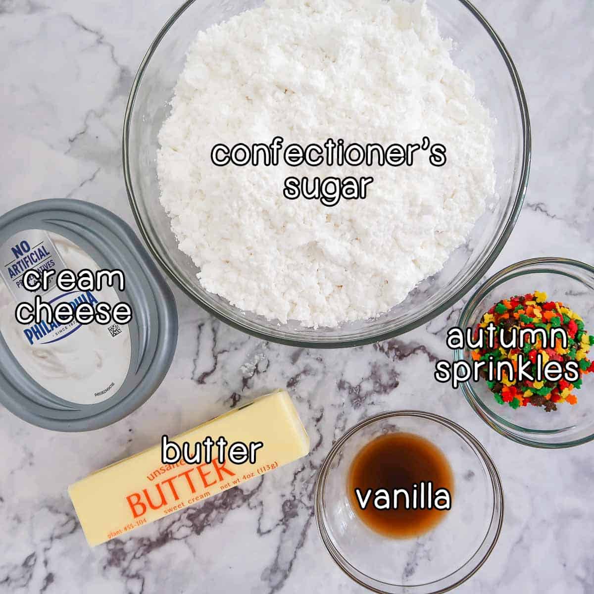 Overhead shot of ingredients for cheesecake filling- confectioner's sugar, cream cheese, butter, vanilla, and autumn sprinkles.