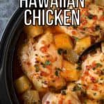 Overhead close up shot of Hawaiian chicken in the crockpot with a black spoon on a grey marble counter.