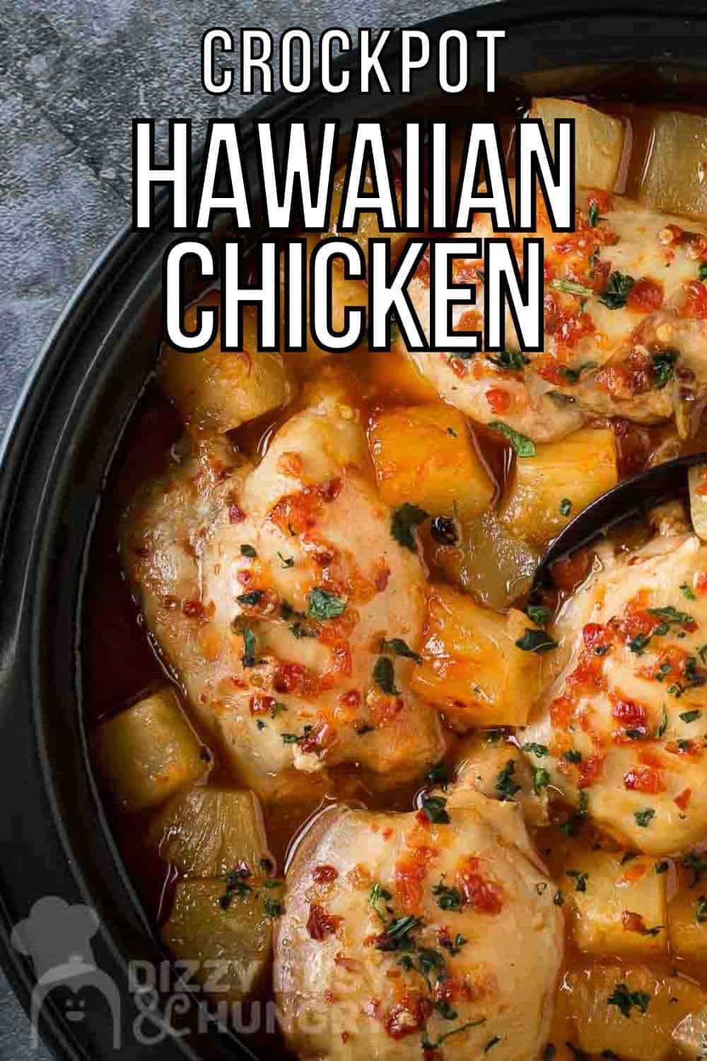 Overhead close up shot of Hawaiian chicken in the crockpot with a black spoon on a grey marble counter.