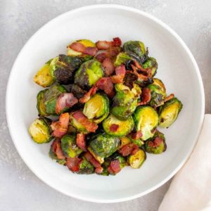 A plate of air fryer brussels sprouts with bacon.