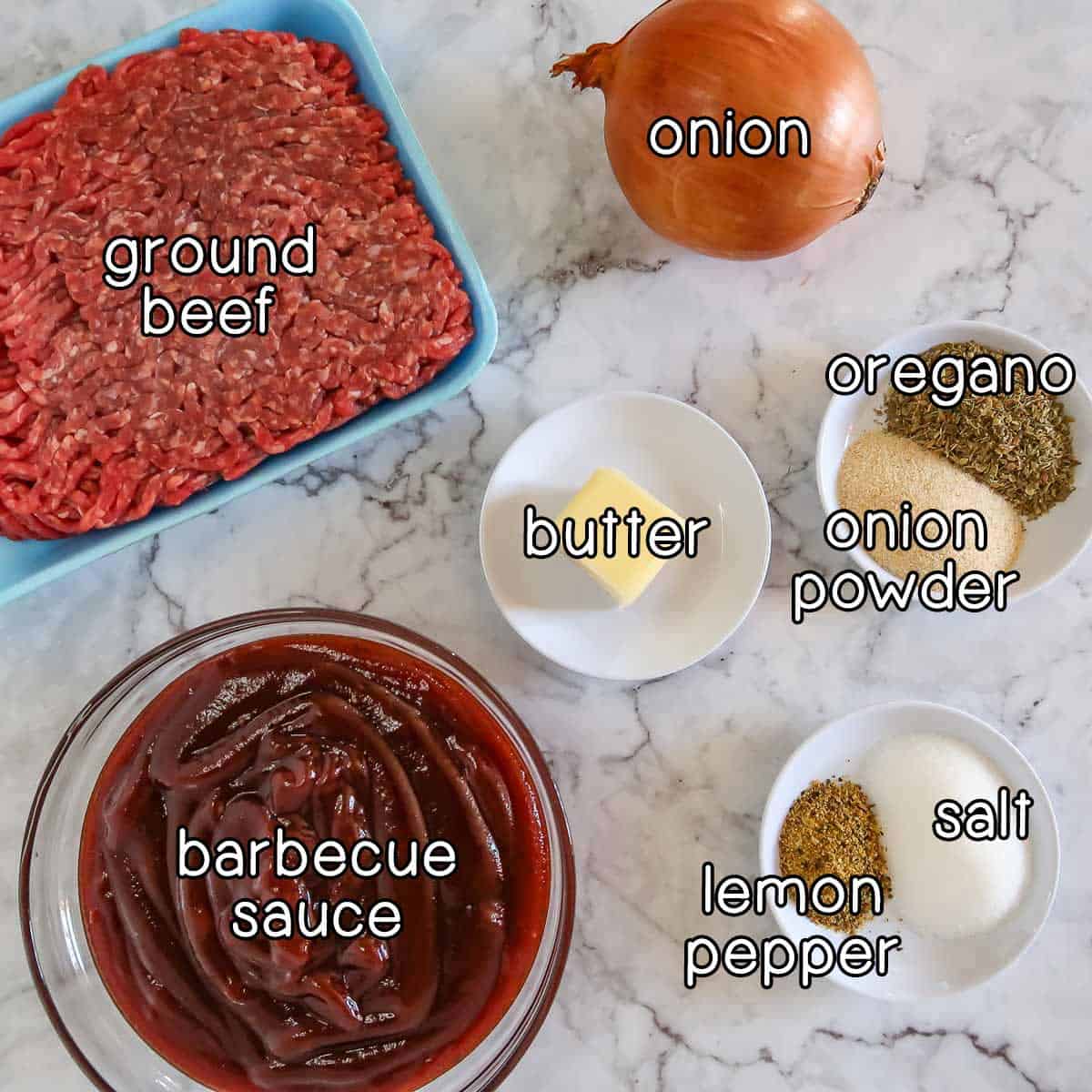 Overhead shot of ingredients - ground beef, onion, butter, barbecue sauce, oregano, onion powder, salt, and lemon pepper.