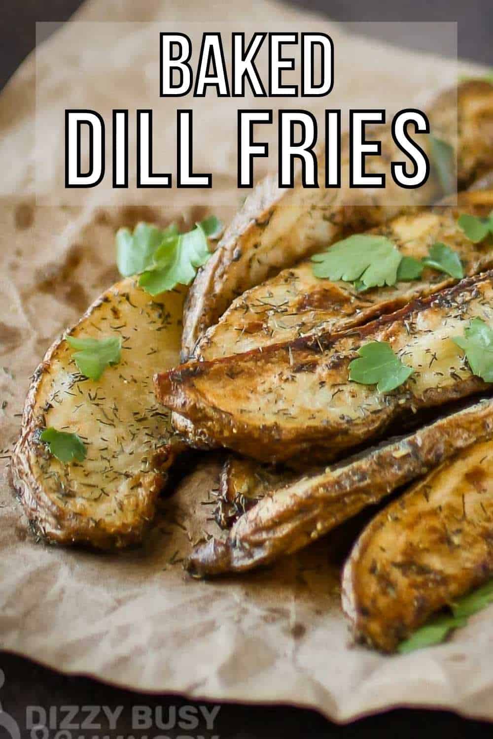 Close up shot of multiple dill French fries garnished with herbs on a brown paper on a black surface.