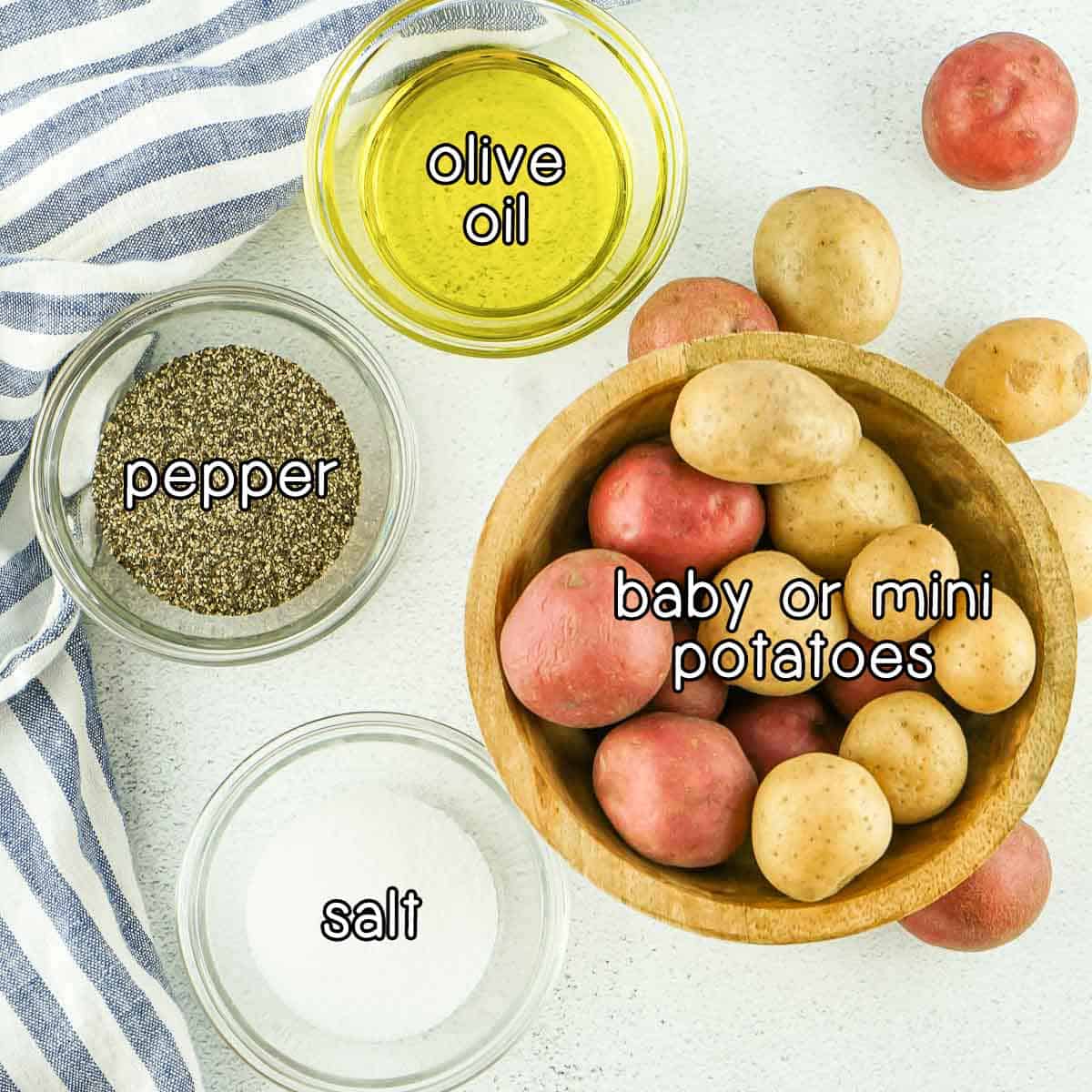 Overhead shot of ingredients - baby/mini potatoes, olive oil, pepper, and salt.