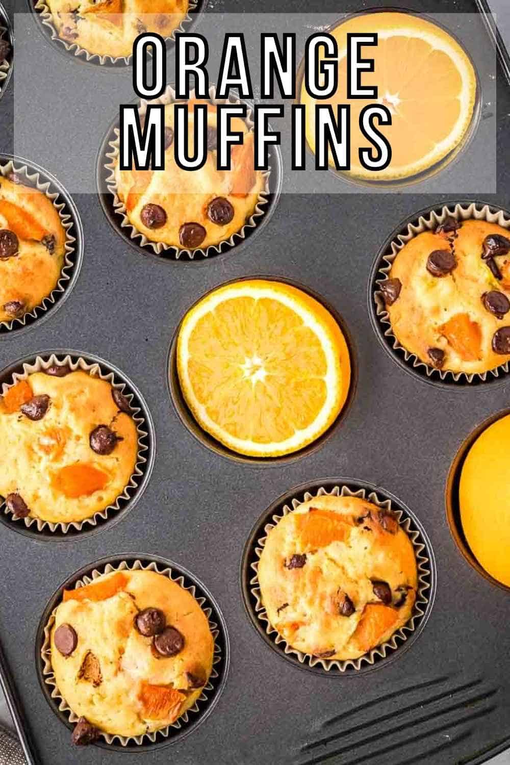Overhead shot of a cupcake sheet filled with orange muffins and half slices of oranges.