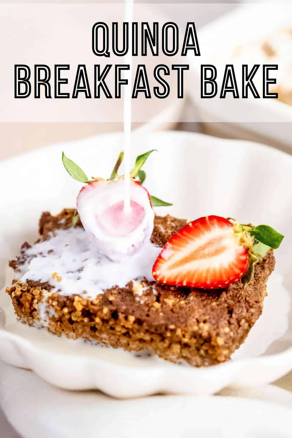 Side close up shot of milk being poured onto quinoa bake garnished with halved strawberries in a white bowl on a white cloth.