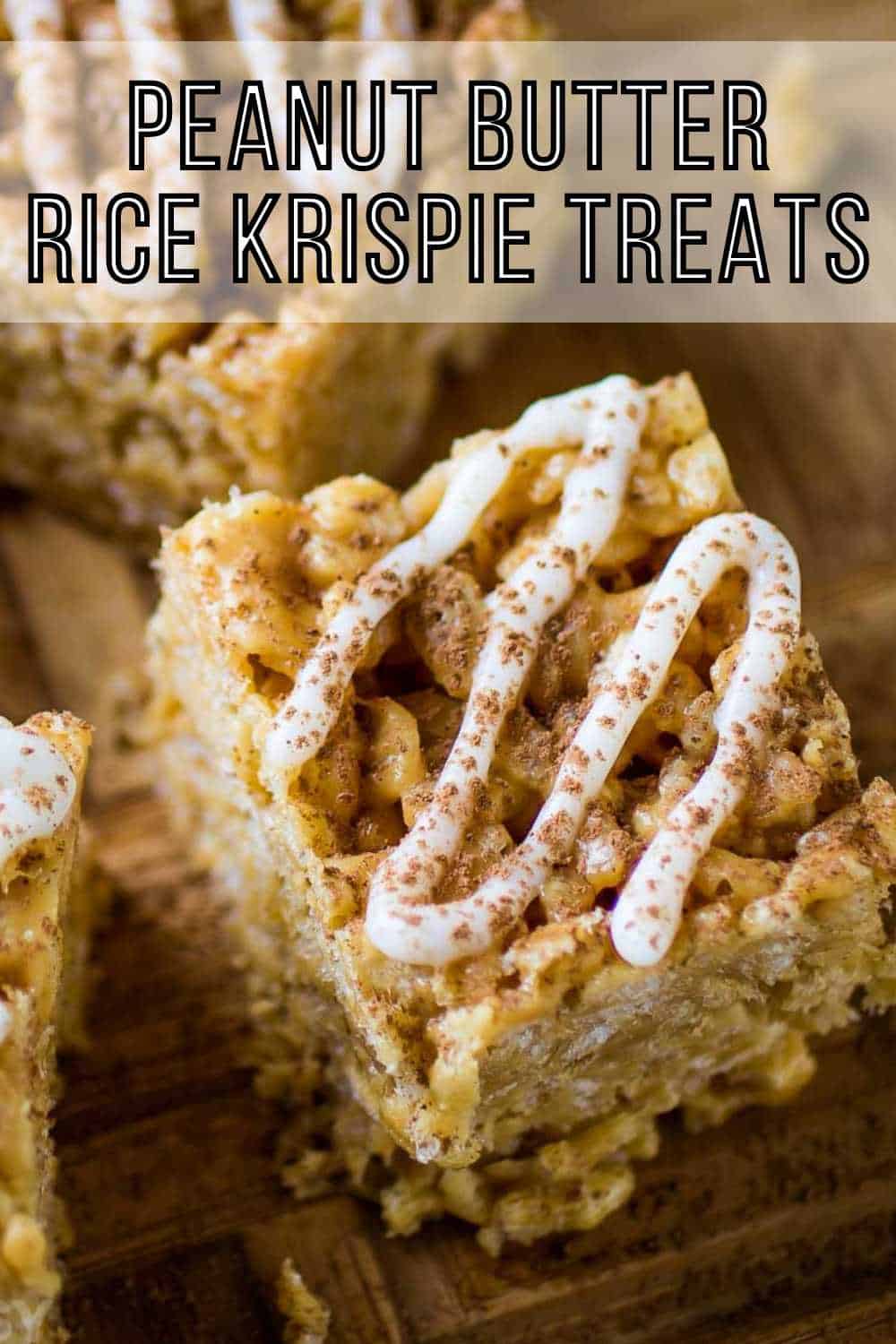 Close up shot of Rice Krispie treats with icing drizzle on a wooden cutting board.