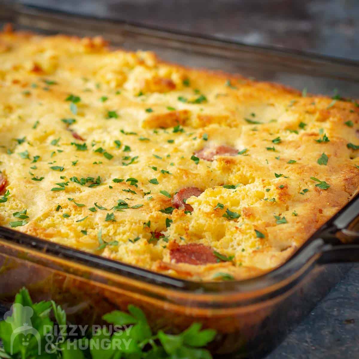 Side close up shot of casserole in a clear dish garnished with fresh herbs.