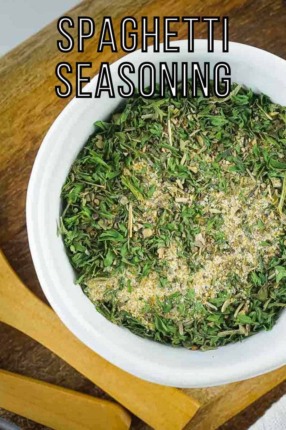 Overhead shot of seasoning in a white bowl on a wooden surface.