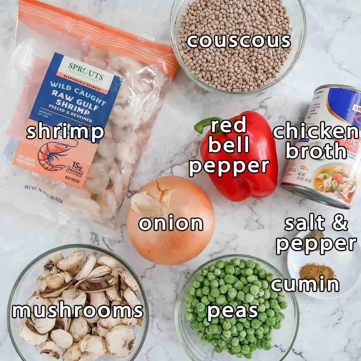 Overhead shot of ingredients - shrimp, couscous, mushrooms, onion, bell pepper, peas, chicken broth, cumin, salt, and pepper.