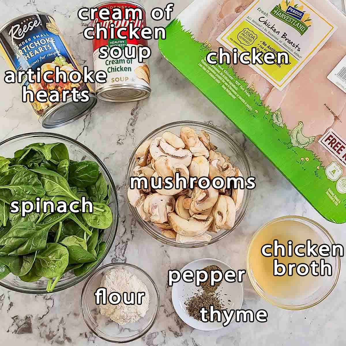 Overhead shot of ingredients - artichoke hearts, cream of chicken soup, chicken, spinach, mushrooms, chicken broth, flour, pepper, and thyme.