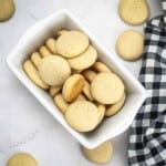 Overhead shot of vanilla wafers in a rectangular ceramic dish on a marble surface and a black and white plaid cloth on the side.