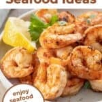 Cooked seasoned shrimp in a white circular dish.