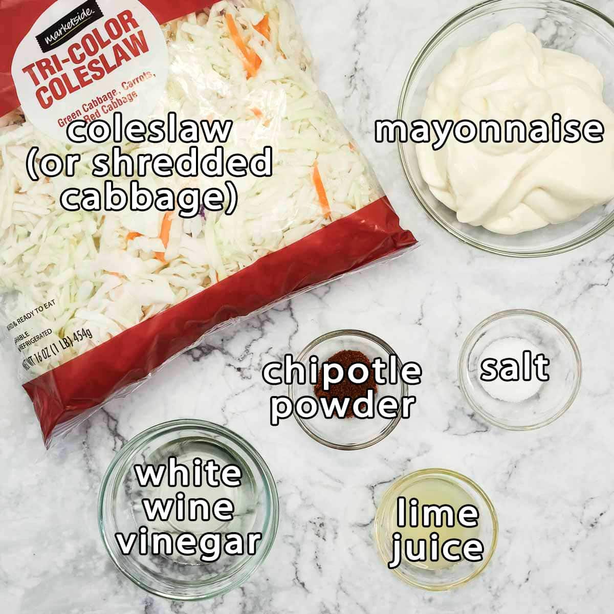 Overhead shot of ingredients - coleslaw (or shredded cabbage), mayonnaise, white wine vinegar, chipotle powder, salt, and lime juice.