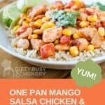 Side shot of mango salsa chicken and butter beans over rice garnished with fresh herbs and lime slices in a white bowl.