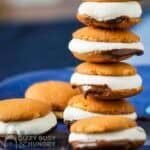 Side shot of multiple microwave s'mores stacked on each other on a blue plate.