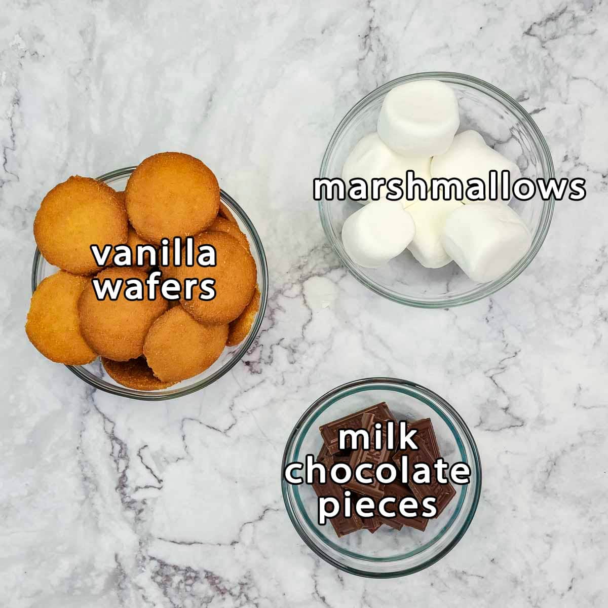 Overhead shot of ingredients - vanilla wafers, marshmallows, and milk chocolate pieces.
